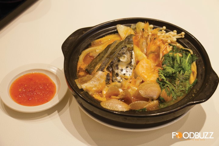 Spicy soup with salmon head, shrimp, clams, mushroom, and Udon.